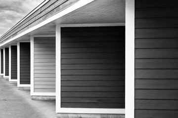 Apartment complex garage doors form repeating pattern in black and white