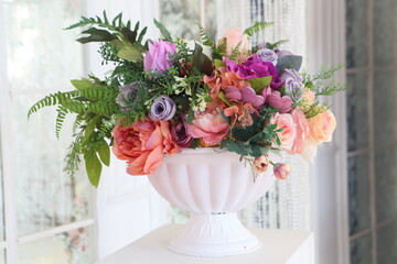 Artificial bouquet of flowers in the interior of a vintage room
