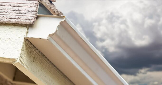 4K Newly Installed Rain Gutter and Drain Downspout with Time-lapse Storm Clouds Behind.