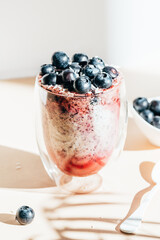 Healthy chia pudding in a glass with fresh blueberries