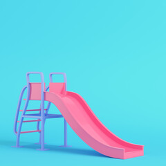 Pink children slide on bright blue background in pastel colors