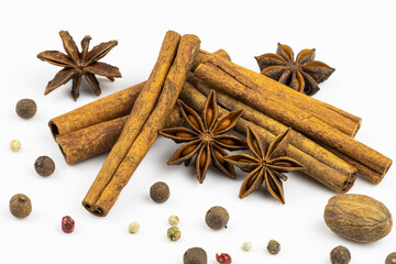 Pepper, nutmeg and anise, cinnamon isolated on a white background.