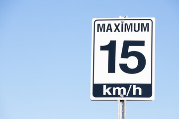 15 km per hour Road Speed Sign with Blue Sky Background. © Sevenstock Studio