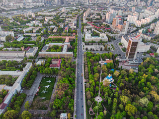 Aerial view of a straight road at green city with the exhibition of military aviation and park area in Kyiv/Kiev city, capital of Ukraine