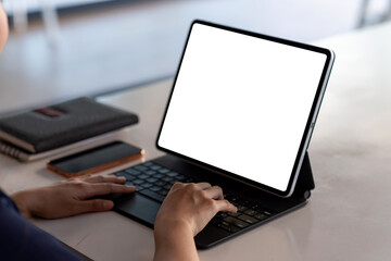 Fototapeta na wymiar Image of the hand woman working printing tablet blank white screen at the office. Mock up.