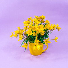 Yellow forest tulips in a yellow cup on a purple background. The basis for the postcard. Mother's Day, 8 March. Place for an inscription.