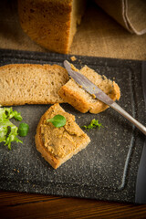 homemade meat pate with bread on a wooden table