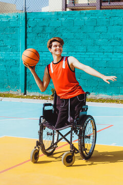 latin young man using wheelchair and playing basketball, disability concept