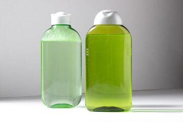 Facial cleanser bottle. Lotion or micellar water for face cleansing. Liquid cosmetic product in green packaging. Natural cosmetics concept