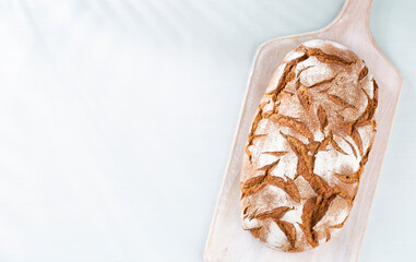 Sliced rye bread on cutting board, closeup..
