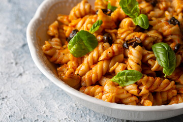 Basil leaves on pasta with arabiata sauce