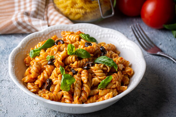 Basil leaves on pasta with arabiata sauce