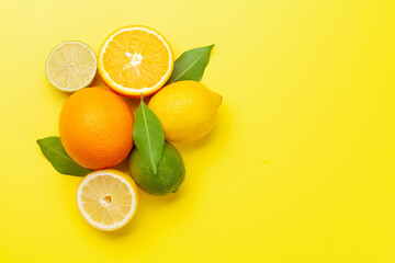 Fresh ripe citrus fruits on yellow background
