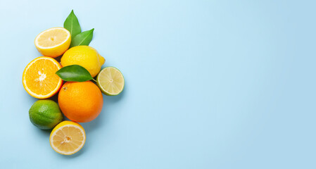 Fresh ripe citrus fruits on blue background