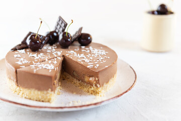 Raw Vegan Chocolate Cherry Mousse Cake. Sugar, gluten and lactose free. Selective focus.