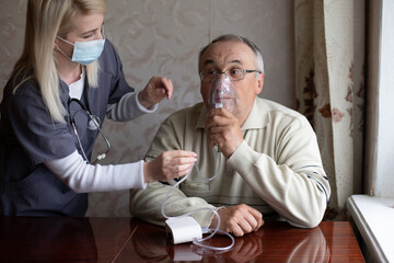 Elderly man on oxygen mask, nebulizer