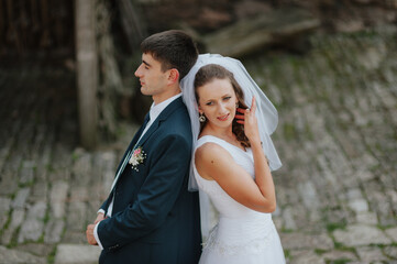 stylish bridal couple posing on their wedding day, happy bride and groom together