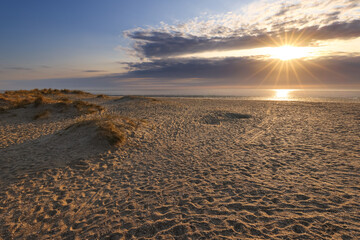 Fototapeta na wymiar Dramatic sky with dunes at beach