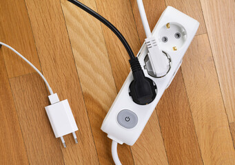 White extension cord with three outlets. Power strip with switch for home or office.