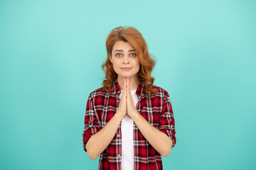 praying redhead woman in checkered shirt. express emotions. hoping lady with curly hair.