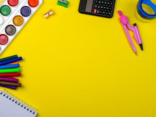 School supplies on a bright yellow background. Stationery on a yellow table. School concept. Back to school. Paints, pencils, rulers and other school items for study