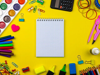 School supplies on a bright yellow background. Copy Space. Stationery on a yellow table. School...