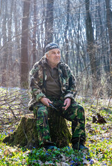 Elderly man on a walk in the woods