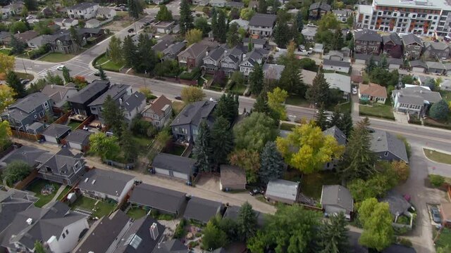Aerial view of houses and streets in typical residential neighbourhood during fall season in Calgary, Alberta, Canada. 