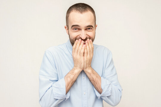 Giggling bearded man covers his mouth from, people's positive emotions concept, white background