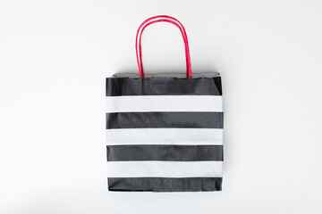 Striped shopping paper bag, white background, copy space