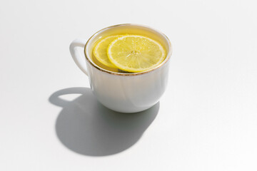 Cup of lemon tea on a white background, copy space, top view
