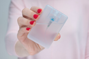 Woman shows sanitizer or antiseptic, woman's hannd, close-up, cropped image