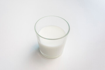 glass of milk, white background, close-up, copy space, top view