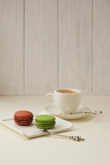 Macaroons on plate on ligtht background. Top view.