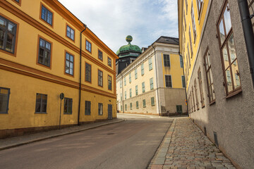 Fototapeta na wymiar Beautiful old buildings view on narrow street. Tourism concept. Europe, Sweden, Uppsala. 
