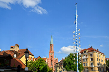 View to historical Maypole at square "Wiener Platz" near the Isar and the Gasteig in the old town of Munich-Haidhausen, Bavaria Germany Europe
