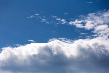 White fluffy clouds in the blue sky. Texture of clouds and sky