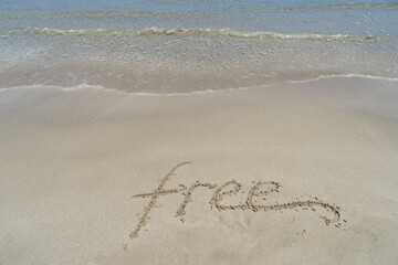free thoughts handwriting in fine sand on the beach inspirational background
