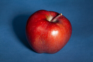 red delicious apple on blue background