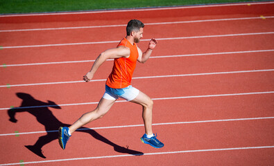 Fototapeta premium physical training. athletic guy run. challenge and competition. marathon speed. sprinter.