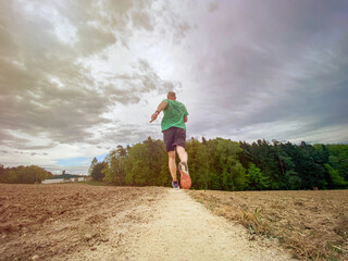 Happy running Sport man in green Spring nature 