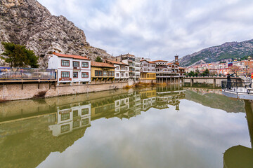 Fototapeta na wymiar Old Ottoman houses panoramic view by the Yesilirmak River in Amasya City. Amasya is populer tourist destination in Turkey.