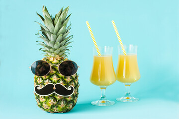 Two glasses of pineapple juice with fresh fruit