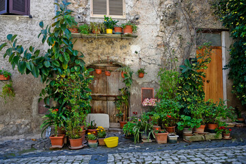 Fototapeta na wymiar Sermoneta, Italy, 05/10/2021. The entrance door to a medieval house in the historic town.