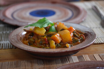 food with vegetables from aegean cuisine on a wooden table. Potato casserole prepared with Aegean herbs