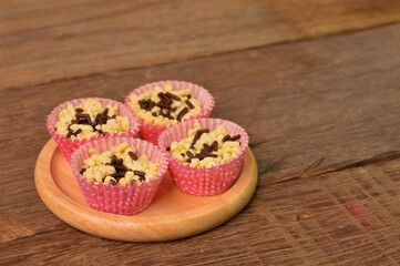 Malaysian traditional homemade cookies called as KUIH SARANG BURUNG on wooden plate