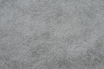 The texture of a gray surface covered with a mixture of sand and cement. Finishing works of...