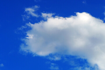 There are few and small clouds in the blue sky,