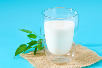 Glass of milk on a blue background. Milk products.