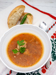 romanian dish ciorba de perisoare or meat balls soup served with hot pepper